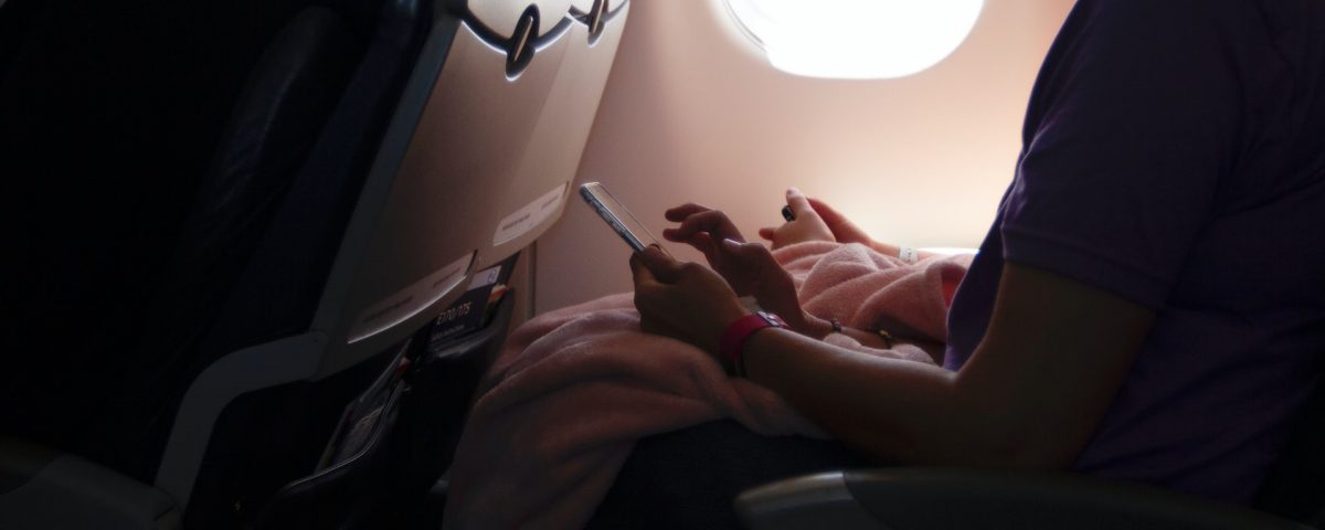 Woman wearing a face mask inside an airplane