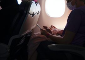 Woman wearing a face mask inside an airplane