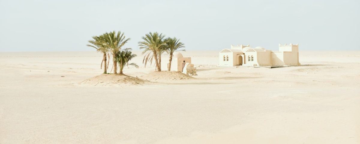 white concrete house in the desert