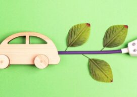 wooden car with a plug and some tree leaves